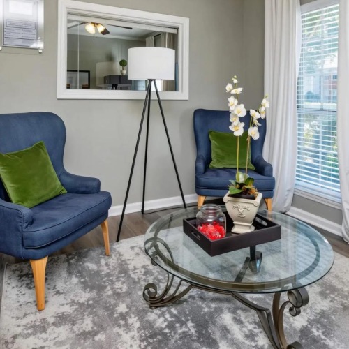 a living room with blue chairs