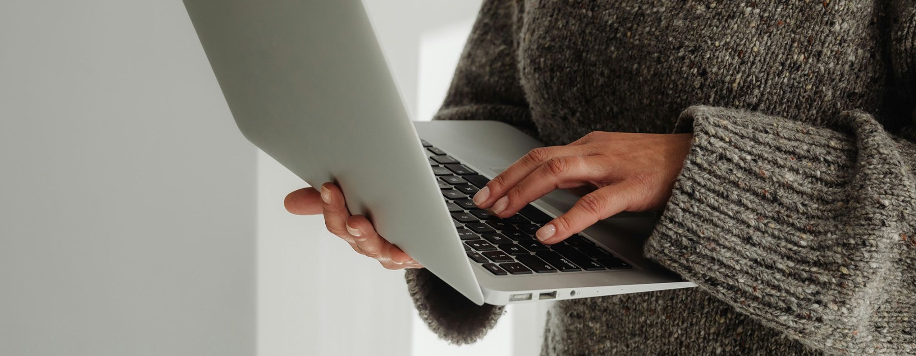 A person holding a laptop.