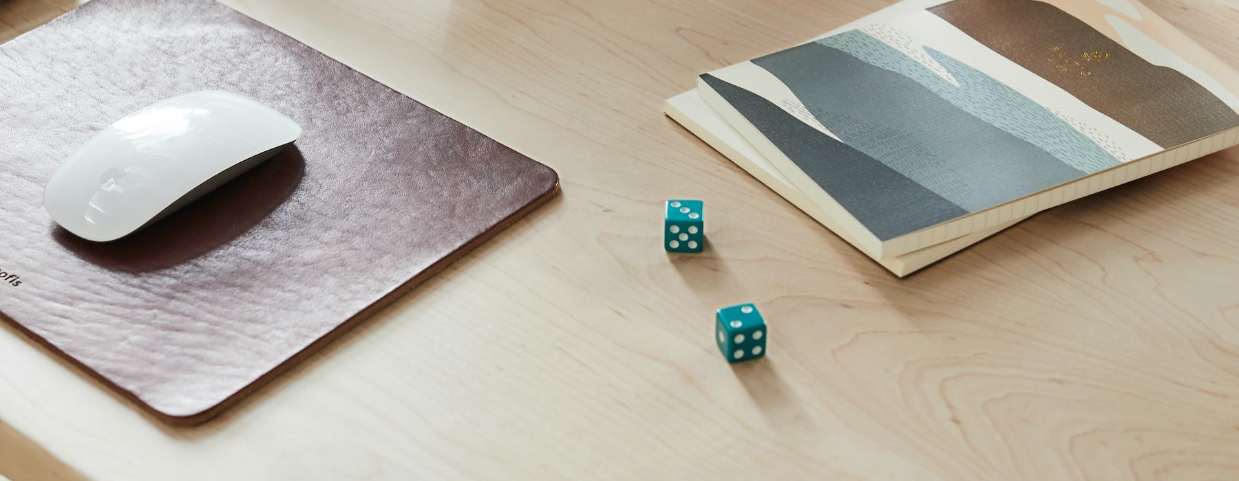a desk with dice and computer equipment