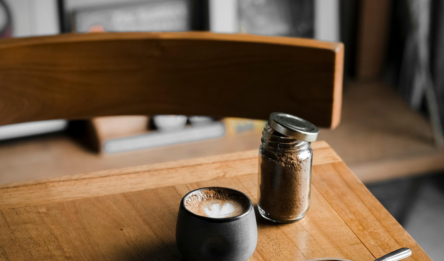 a table with a couple of small metal containers and a spoon
